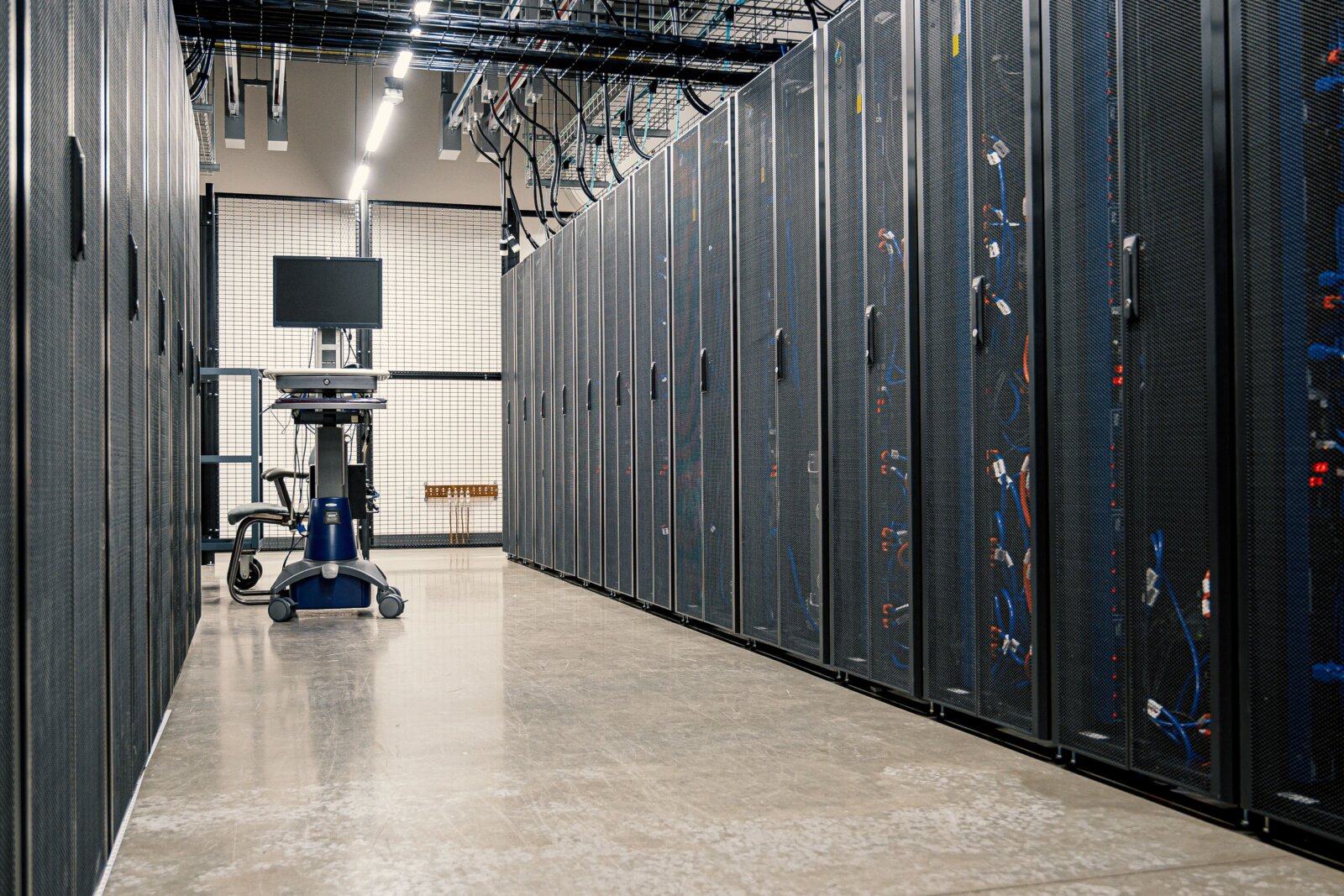 Rows of server cabinets lining a data-centre aisle.